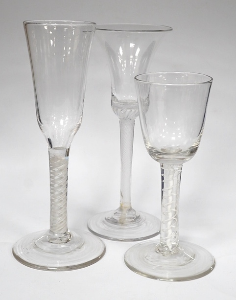 Three DSOT stem drinking glasses, c.1760, tallest 18.5 cm high. Condition - the ale glass - tiny splinter chip to the under edge of base, the wine glass with round funnel - good condition, the wine glass with a bell bowl